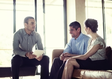 Couple meeting with young male advisor